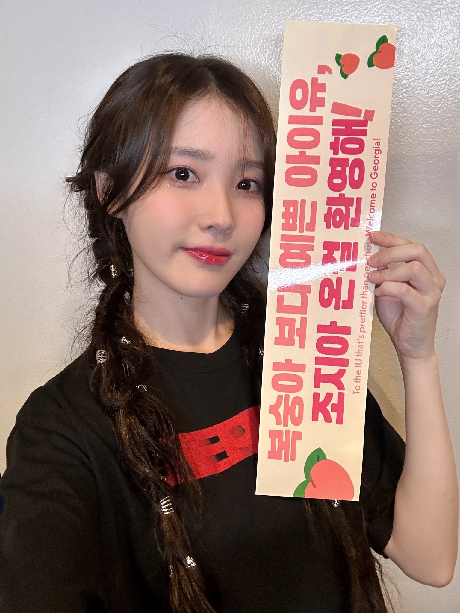 Kpop singer IU holding a banner
